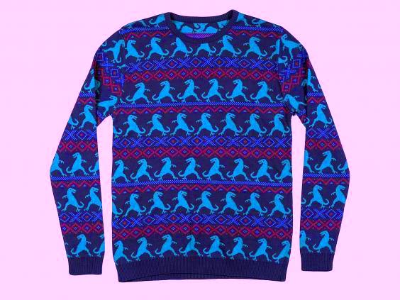 A purple-esq jumper with light blue Dinosaur detailing